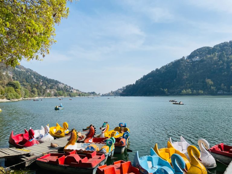 people riding on red kayak boat on sea during daytime